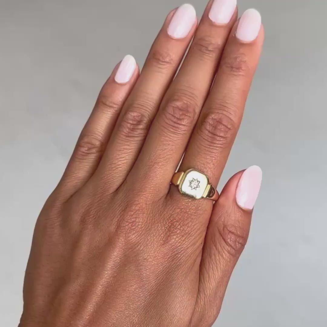 Antique - Hand wearing a gold ring with a diamond on a gray background