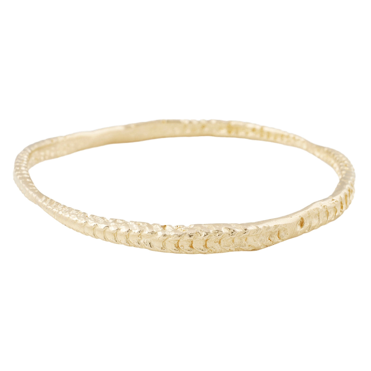 Textured gold bangle against a white background - Lauren Wolf Jewelry | ESQUELETO