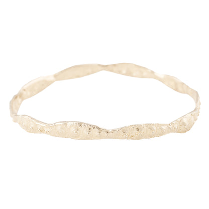 Sea urchin textured gold bangle pictured on a white background - Lauren Wolf Jewelry | ESQUELETO 