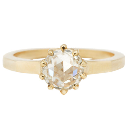 Lauren Wolf - Gold ring with a large diamond on a white background