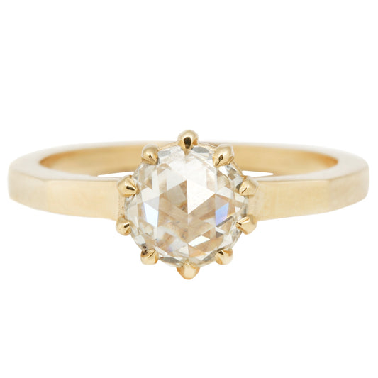 Lauren Wolf - Gold ring with a large diamond on a white background