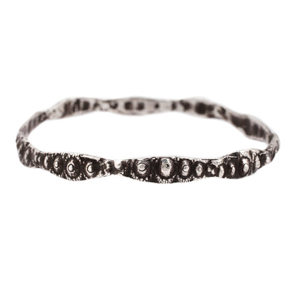 textured silver bangle with oxidized finish against a white background - Lauren Wolf Jewelry | ESQUELETO 