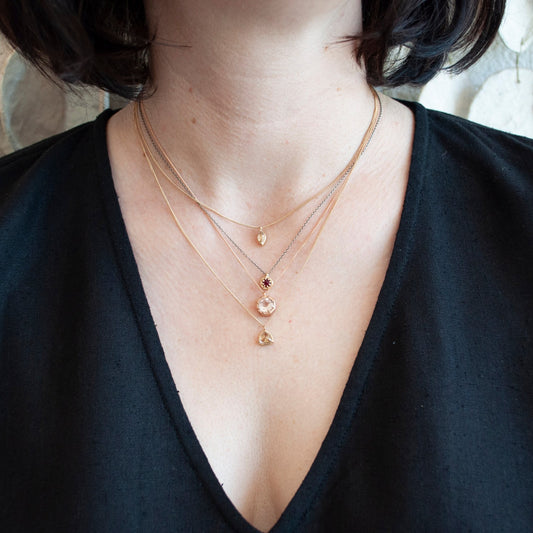 Gold Marquise Morganite Necklace by Lauren Wolf, shown styled on the neck with other pieces in her collection