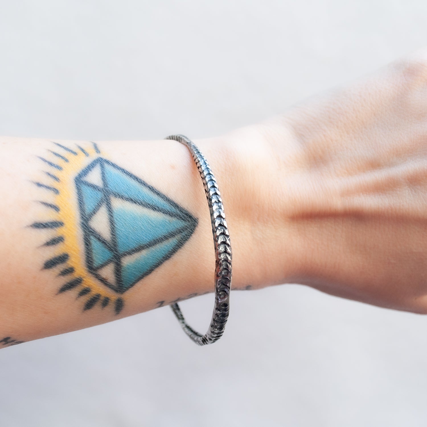 Textured oxidized silver bracelet worn on the wrist - Lauren Wolf Jewelry | ESQUELETO
