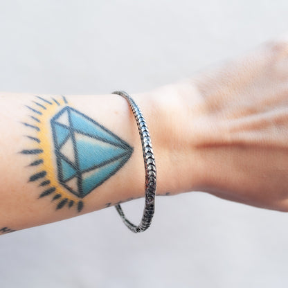 Textured oxidized silver bracelet worn on the wrist - Lauren Wolf Jewelry | ESQUELETO