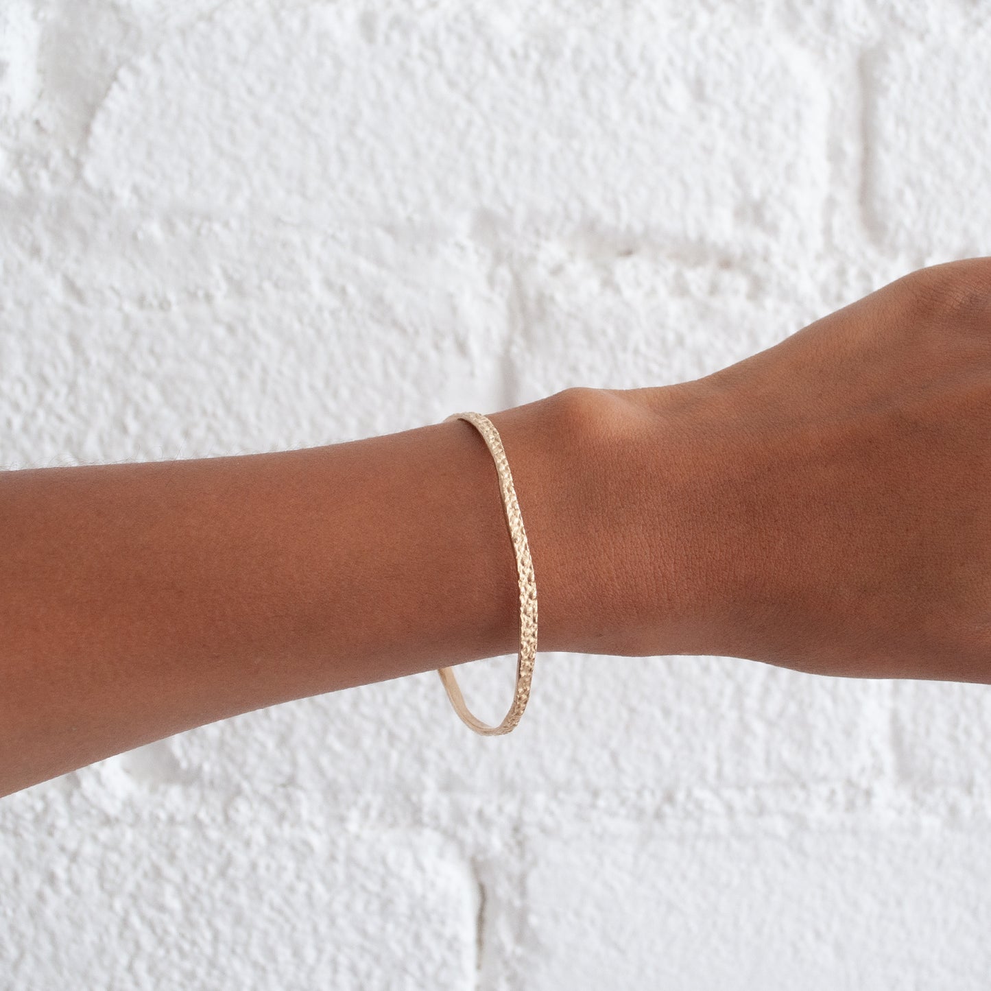 14k Gold Stingray Bangle from Lauren Wolf Jewelry shown on the wrist