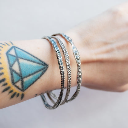 textured silver bangle with oxidized finish worn on wrist - Lauren Wolf Jewelry | ESQUELETO 