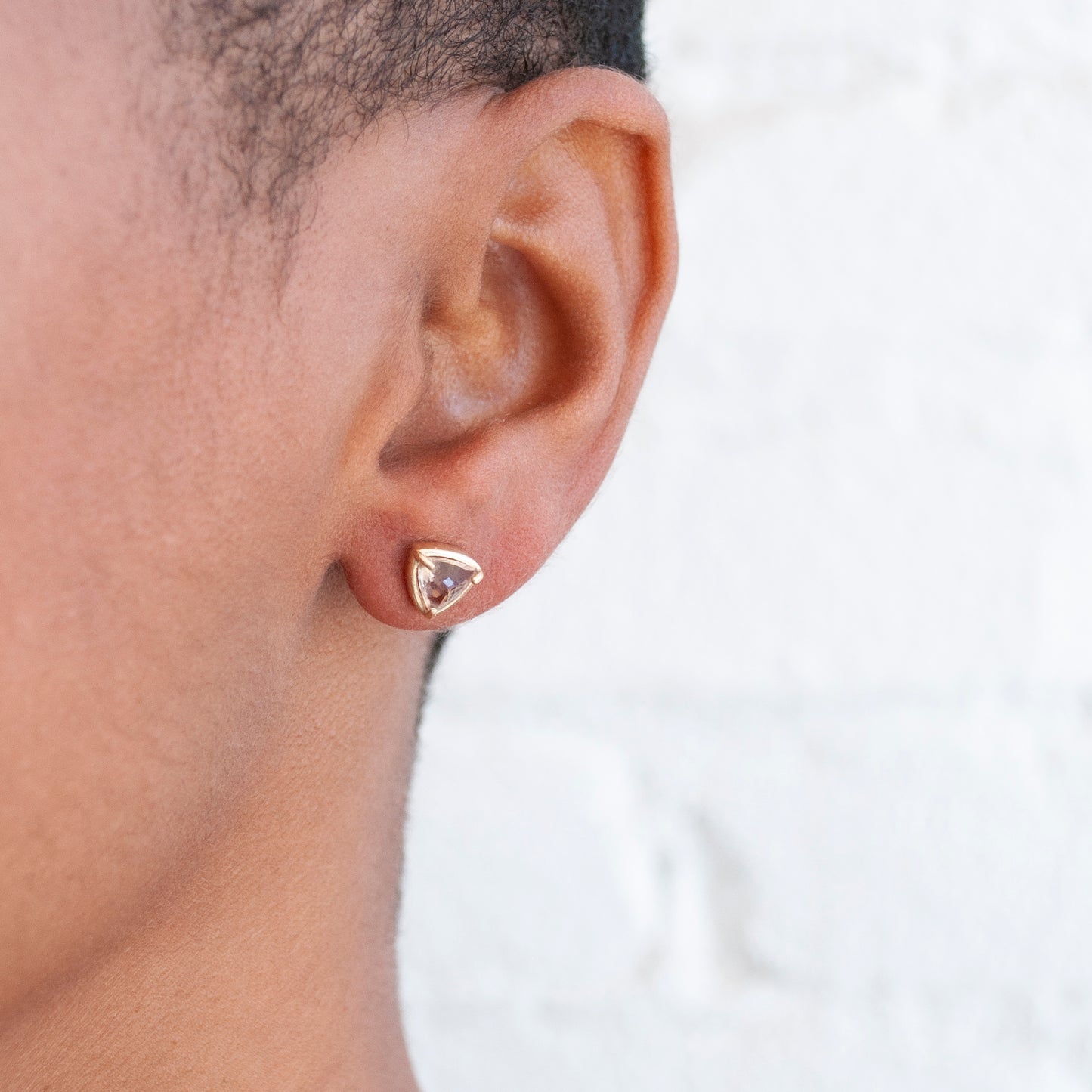 Lauren Wolf Jewelry - 14k yellow gold stud earrings with trillion cut morganite on an ear 