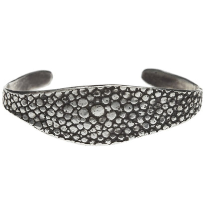 textured oxidized silver bangle against a white backdrop - Lauren Wolf Jewelry | ESQUELETO